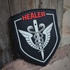 Логотип телеграм канала @healertacmedshop — ХИЛЕР I МЕРЧ I HEALER